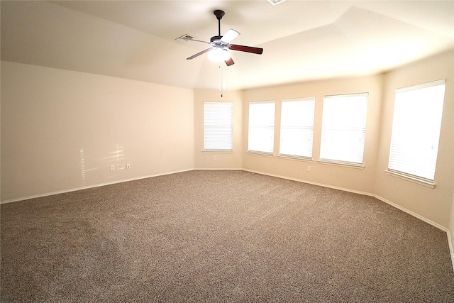 spare room with carpet flooring, ceiling fan, visible vents, and baseboards