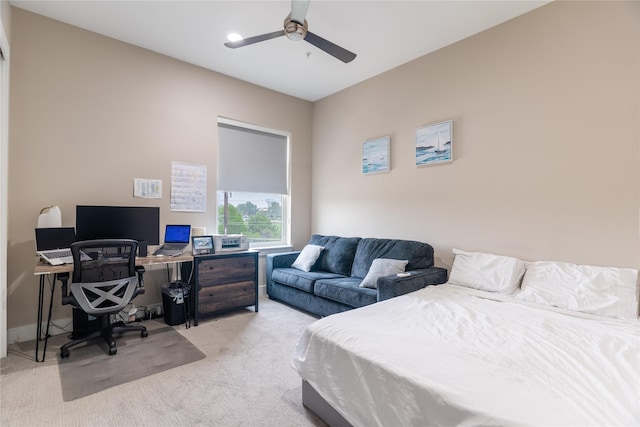 bedroom with a ceiling fan and light colored carpet