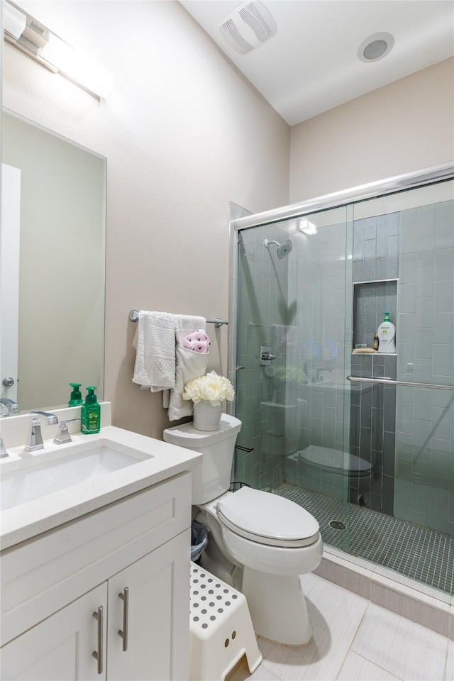 full bath with visible vents, vanity, toilet, tile patterned floors, and a stall shower