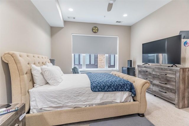 carpeted bedroom featuring ceiling fan and visible vents