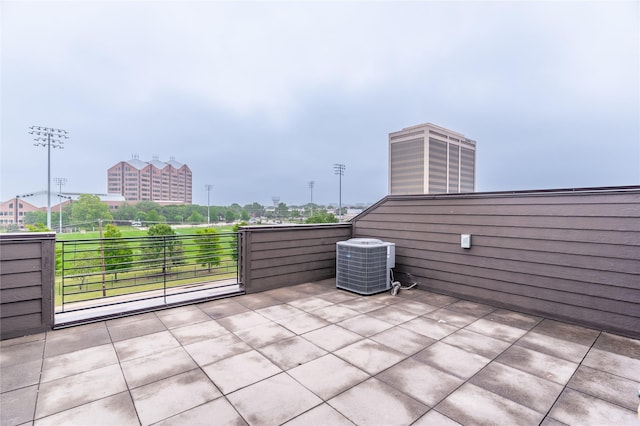 view of patio / terrace with cooling unit and a balcony