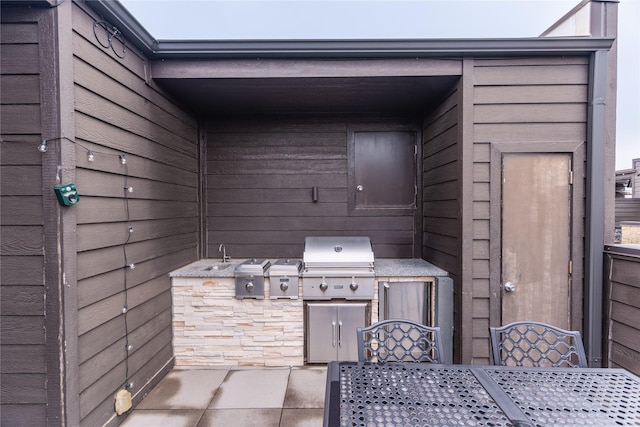 view of patio / terrace featuring area for grilling, exterior kitchen, and outdoor dining space