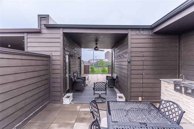 view of patio / terrace featuring grilling area, a ceiling fan, outdoor dining area, and an outdoor hangout area