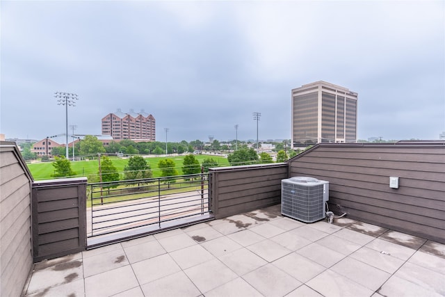 view of patio with central air condition unit and a balcony