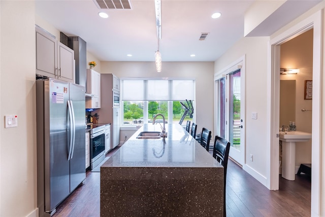 kitchen featuring plenty of natural light, a sink, appliances with stainless steel finishes, and visible vents