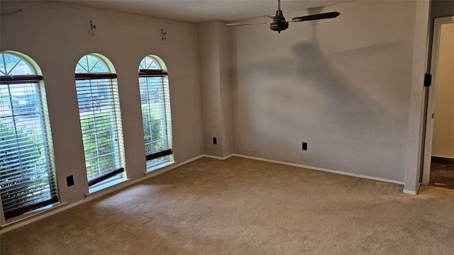 empty room with baseboards, carpet flooring, and a ceiling fan