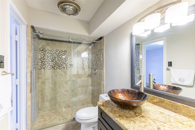 2418 Ingleside Dr, Grand Prairie, TX 75050 - bathroom with a shower stall, vanity, and toilet