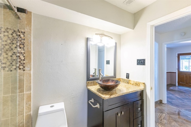 2418 Ingleside Dr, Grand Prairie, TX 75050 - full bath with vanity, toilet, and a tile shower