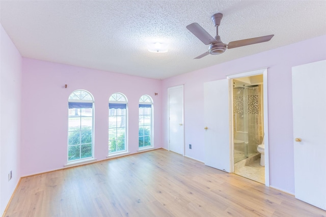 2418 Ingleside Dr, Grand Prairie, TX 75050 - unfurnished bedroom with light wood-type flooring, a textured ceiling, and ensuite bathroom