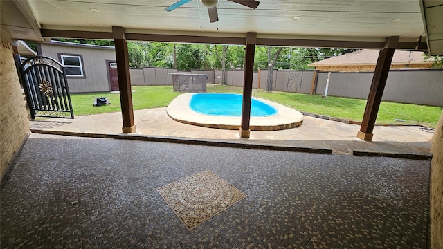 view of pool featuring ceiling fan, a patio, a fenced backyard, a fenced in pool, and a yard