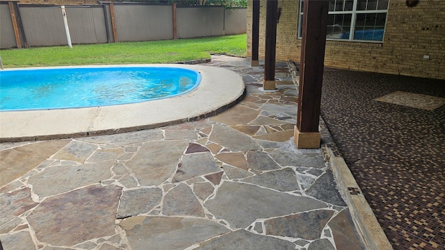 view of pool with a fenced in pool, fence, and a patio