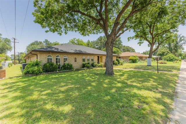 2418 Ingleside Dr, Grand Prairie, TX 75050 - ranch-style house with a front lawn, central AC unit, and brick siding