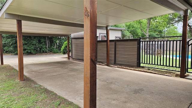 view of patio / terrace with fence and a carport