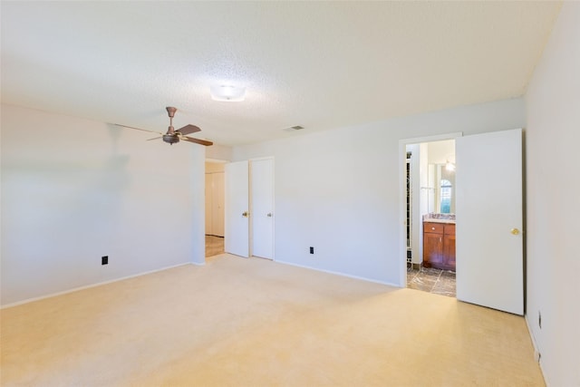 2418 Ingleside Dr, Grand Prairie, TX 75050 - unfurnished room featuring ceiling fan, light colored carpet, baseboards, and a textured ceiling
