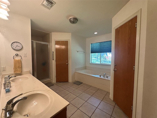 824 Imogene Ct, Azle, TX 76020 - bathroom featuring visible vents, a sink, a garden tub, and tile patterned flooring