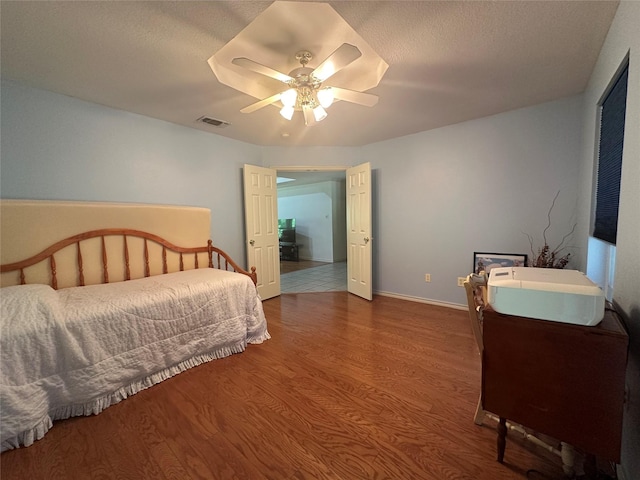 824 Imogene Ct, Azle, TX 76020 - bedroom featuring baseboards, ceiling fan, wood finished floors, and visible vents