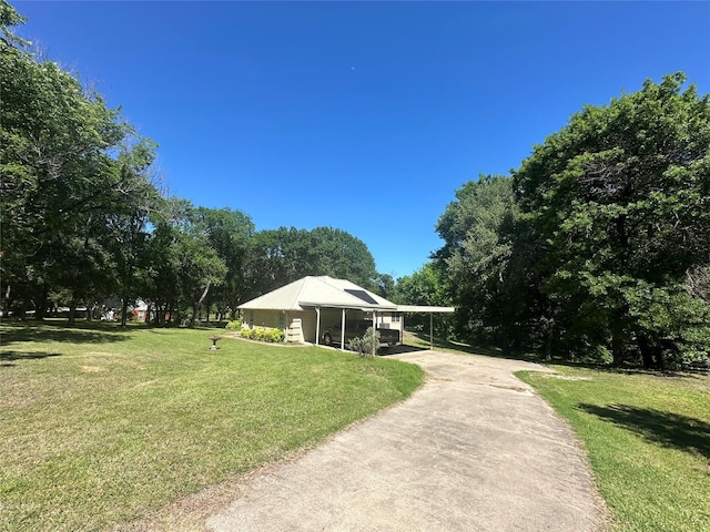 824 Imogene Ct, Azle, TX 76020 - view of property's community featuring a lawn, a carport, and concrete driveway
