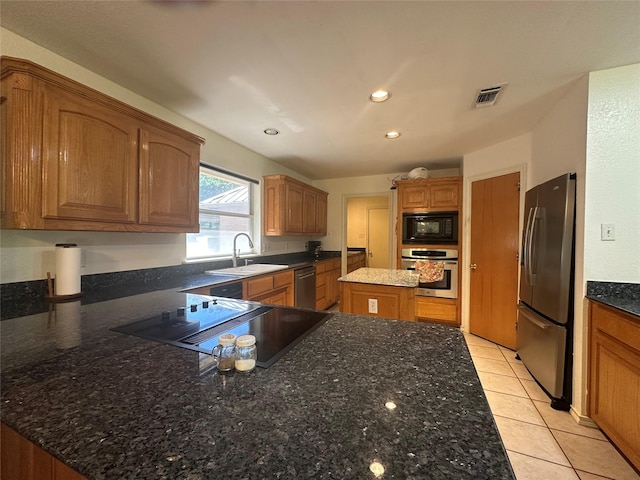 824 Imogene Ct, Azle, TX 76020 - kitchen featuring visible vents, a sink, black appliances, a peninsula, and dark stone counters
