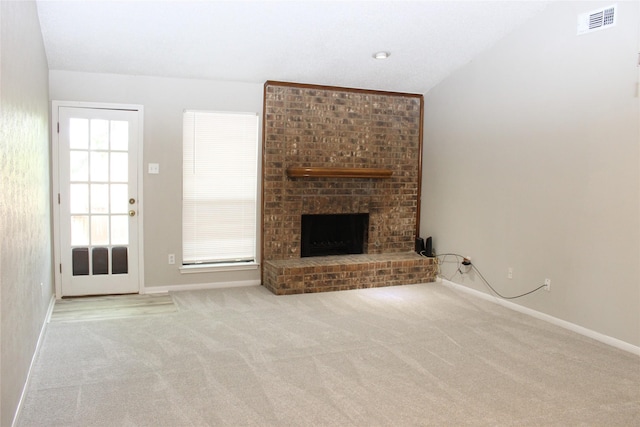 unfurnished living room with carpet flooring, baseboards, visible vents, and a brick fireplace