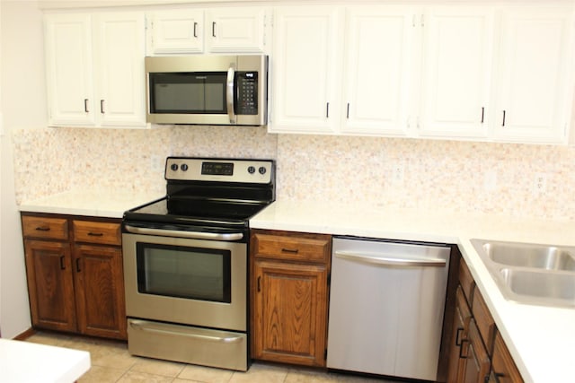 kitchen with decorative backsplash, appliances with stainless steel finishes, and light countertops