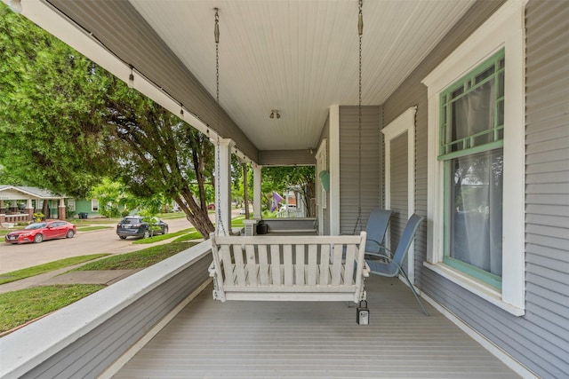 wooden terrace featuring covered porch