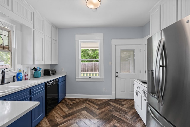 kitchen featuring light countertops, blue cabinetry, stainless steel fridge, and dishwasher