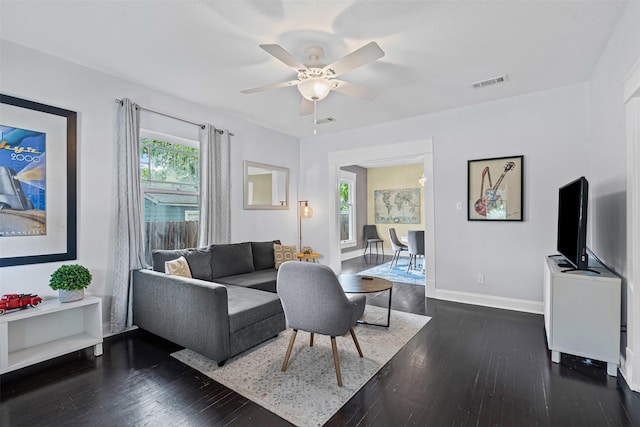 living room with visible vents, a ceiling fan, wood-type flooring, and baseboards