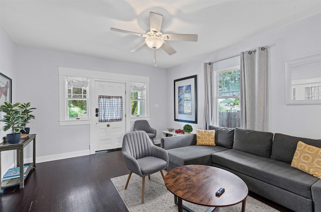living room featuring baseboards, a ceiling fan, dark wood-style flooring, and a healthy amount of sunlight