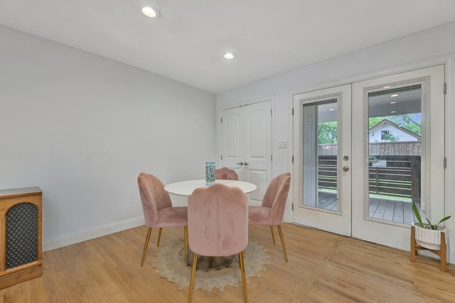 dining room featuring french doors, light wood-type flooring, baseboards, and recessed lighting