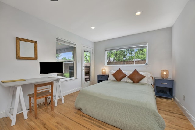 bedroom with access to outside, wood finished floors, baseboards, recessed lighting, and an office area