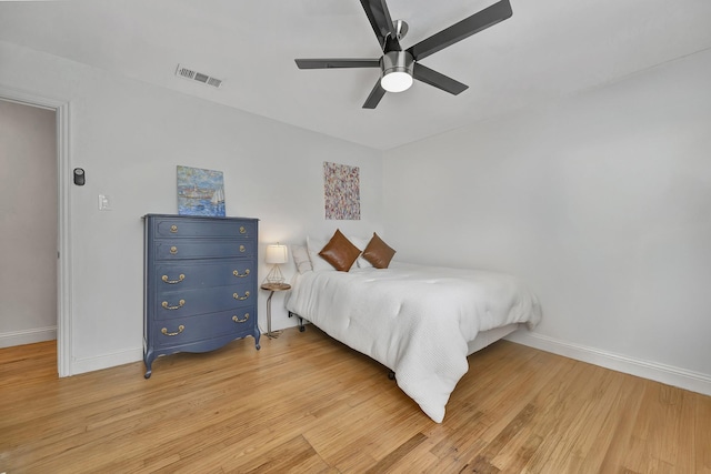 bedroom with baseboards, light wood-style floors, and ceiling fan