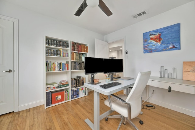office area featuring ceiling fan, light wood-type flooring, and baseboards