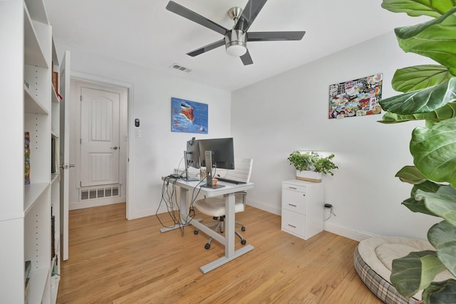 home office with a ceiling fan, light wood-type flooring, and baseboards