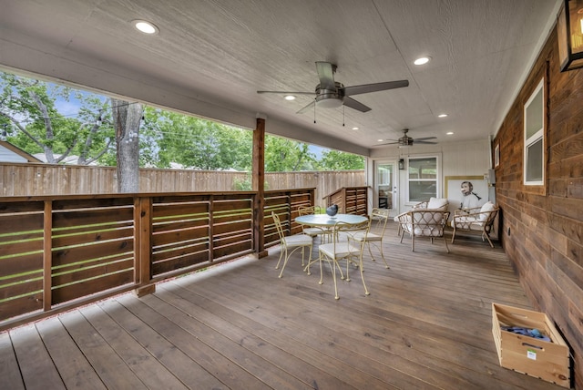 deck with ceiling fan and fence