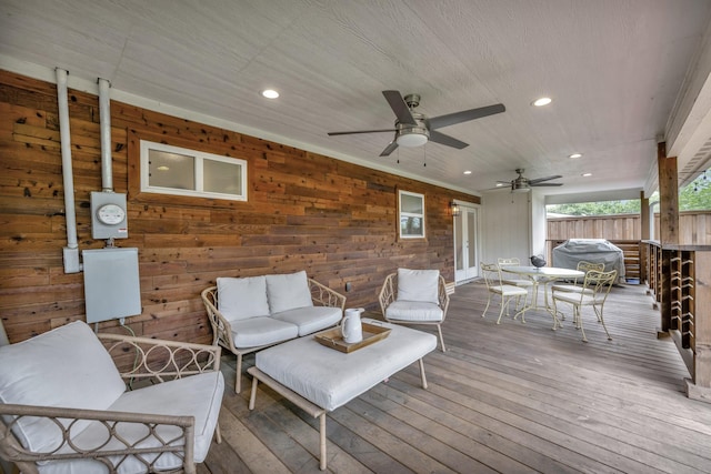 wooden deck with outdoor dining space, outdoor lounge area, and ceiling fan