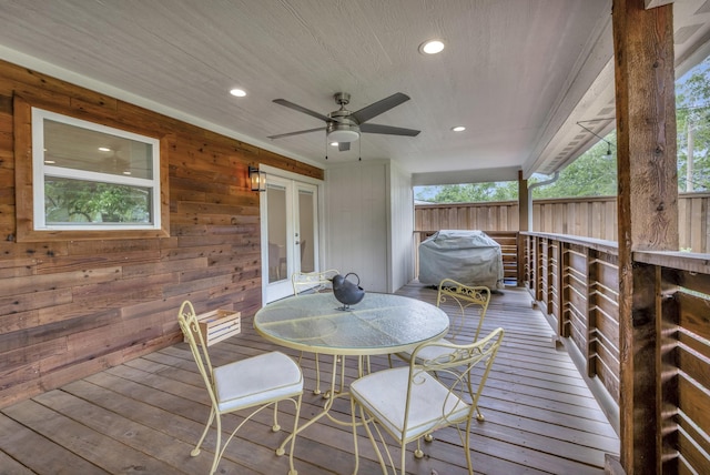 wooden terrace featuring grilling area, a ceiling fan, and french doors
