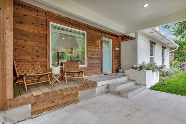 doorway to property with brick siding