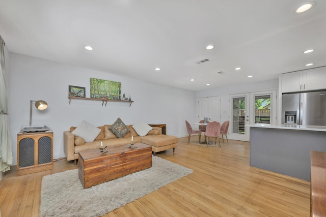 living room featuring light wood-style flooring and recessed lighting