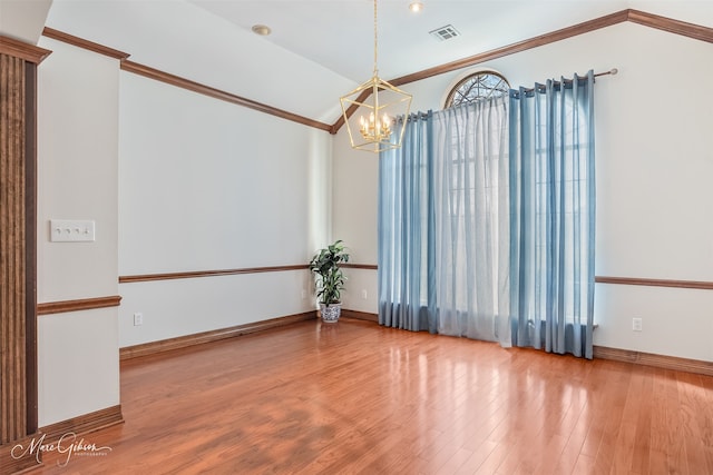 unfurnished room featuring crown molding, a notable chandelier, baseboards, wood finished floors, and visible vents