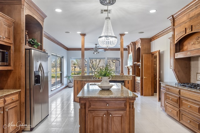 kitchen featuring a center island, stainless steel appliances, light tile patterned floors, visible vents, and ornamental molding