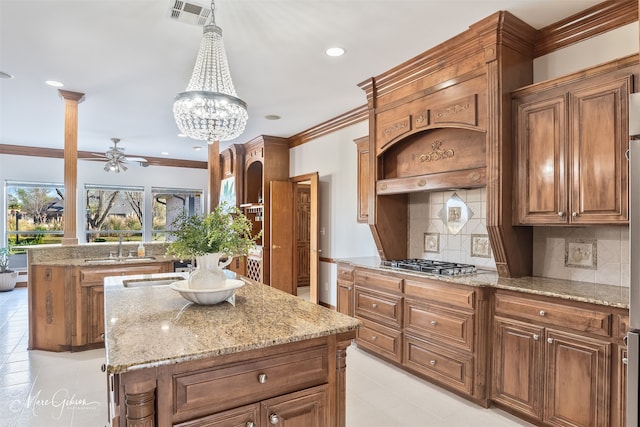 kitchen featuring a kitchen island, light tile patterned floors, visible vents, and stainless steel gas stovetop