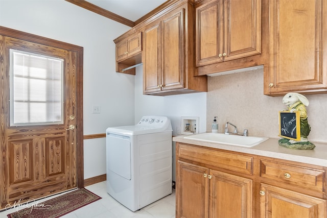 washroom featuring washer / clothes dryer, crown molding, cabinet space, a sink, and light tile patterned floors