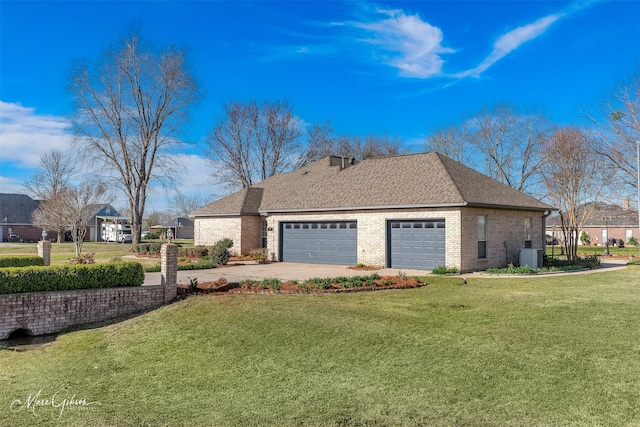view of home's exterior with brick siding, a garage, central AC unit, concrete driveway, and a yard