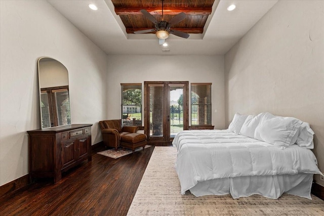 bedroom with dark wood-style flooring, ceiling fan, access to outside, a raised ceiling, and recessed lighting