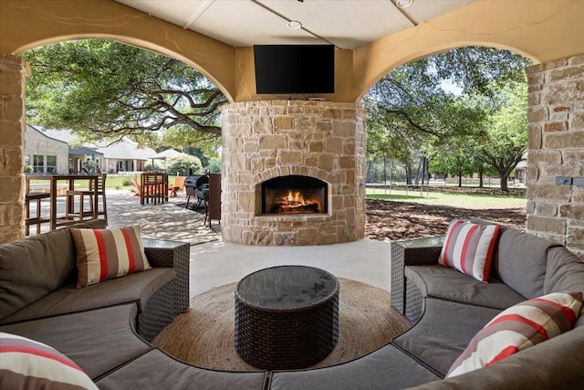 view of patio / terrace with an outdoor living space with a fireplace