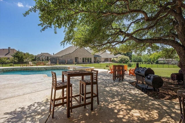 view of pool featuring a fenced in pool, a patio area, fence, and a yard