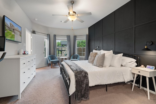 bedroom featuring visible vents, a ceiling fan, and light colored carpet