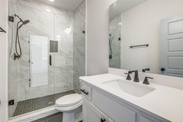 full bath featuring vanity, a stall shower, and toilet