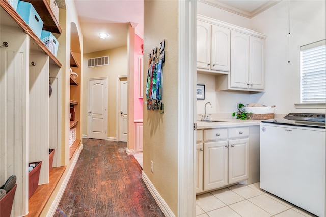 107 Harvest Ridge Cv, Mclendon Chisholm, TX 75032 - kitchen with visible vents, ornamental molding, washer / dryer, white cabinets, and a sink