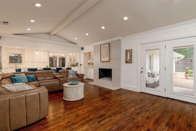7449 Tophill Ln, Dallas, TX 75248 - living area featuring dark wood-type flooring, a fireplace with flush hearth, recessed lighting, and a decorative wall